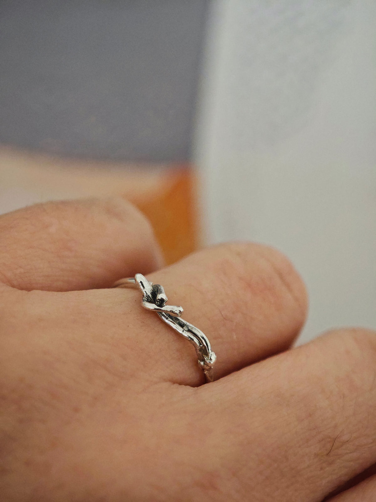 One-of-a-kind sterling silver sculptural ring with reclining human figure, worn on hand, size 55.5–56