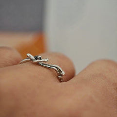 One-of-a-kind silver reclining figure ring on white background, size 55.5–56