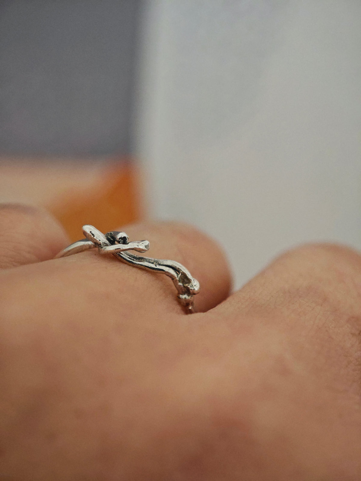 One-of-a-kind silver reclining figure ring on white background, size 55.5–56