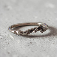 Sculptural silver ring with human form resting across the band, handmade in Athens