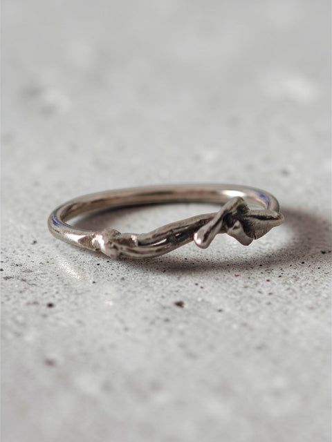 Sculptural silver ring with human form resting across the band, handmade in Athens