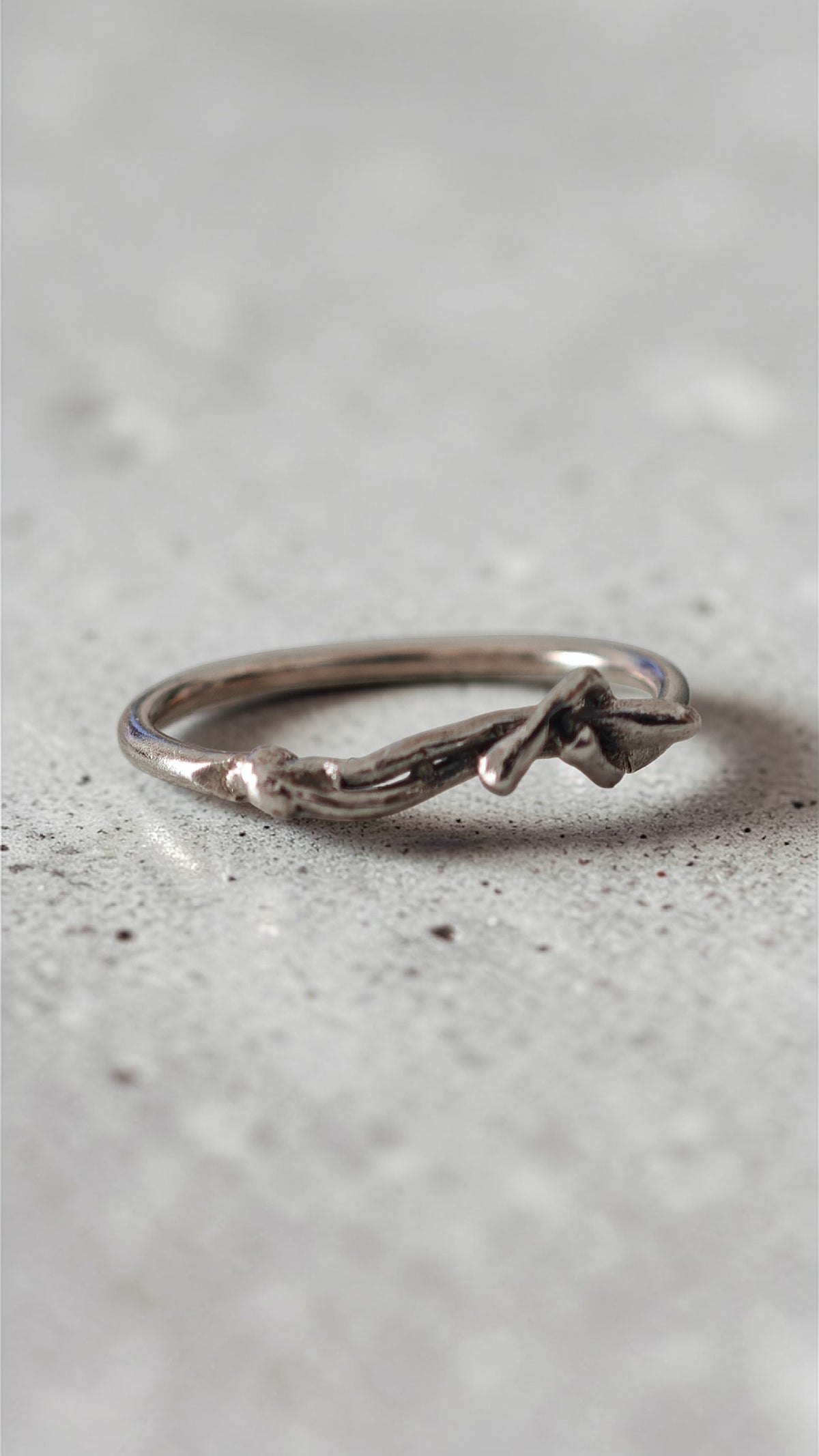 Sculptural silver ring with human form resting across the band, handmade in Athens