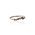 Close-up of handmade silver figure ring showing oxidized details and sculptural form