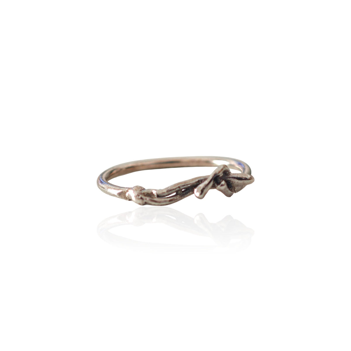 Close-up of handmade silver figure ring showing oxidized details and sculptural form