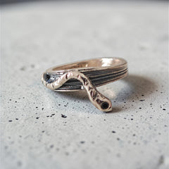 One-of-a-kind sterling silver serpent ring with oxidized details on grey surface, size 53