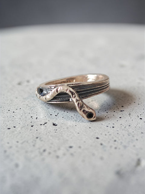 One-of-a-kind sterling silver serpent ring with oxidized details on grey surface, size 53