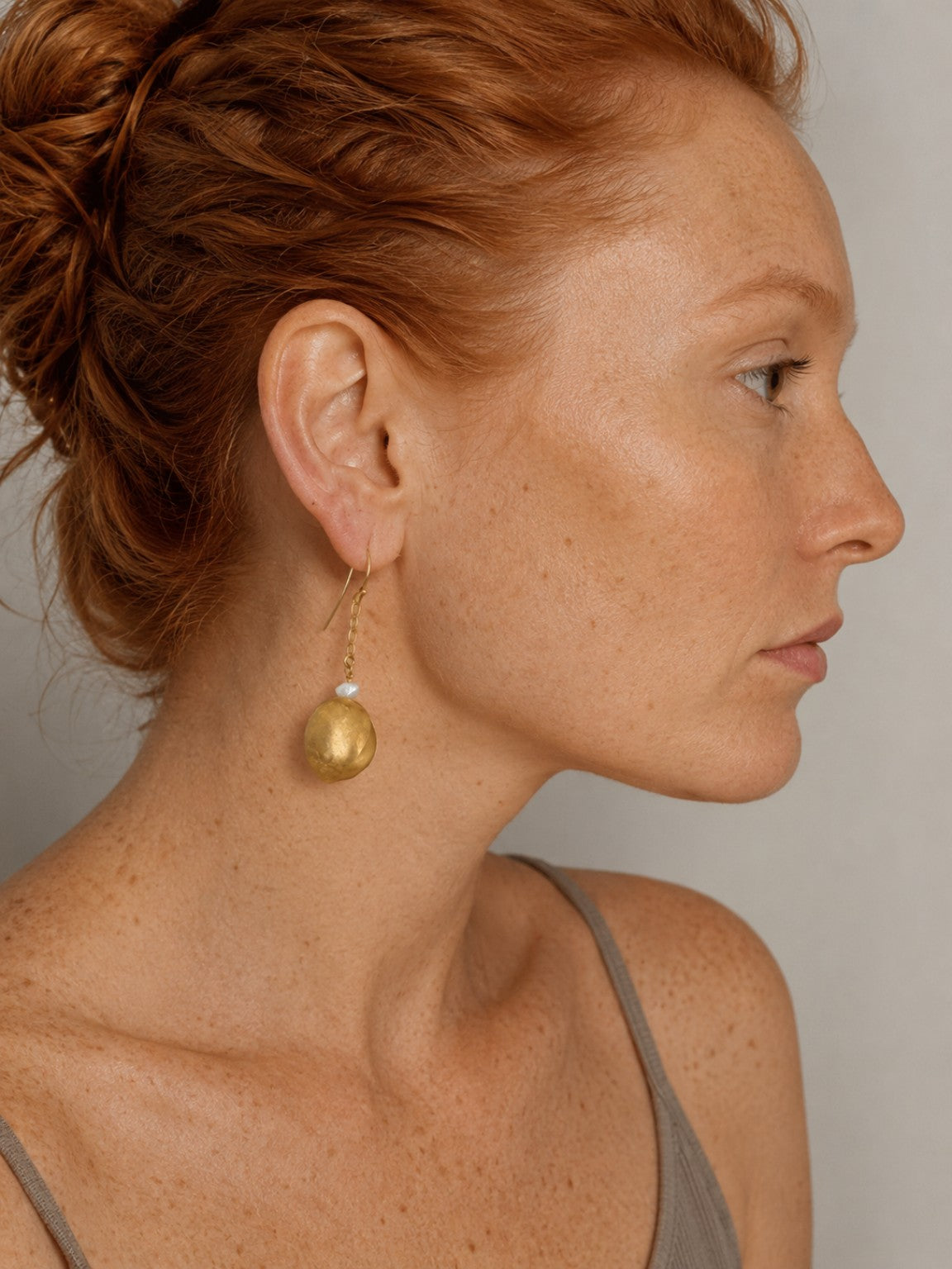 Ginger-haired model wearing Hidden Treasures Kelifos Pearl Earrings.