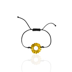Black cord bracelet with a gold circular charm on a white background. Sun Lucky charm forever 