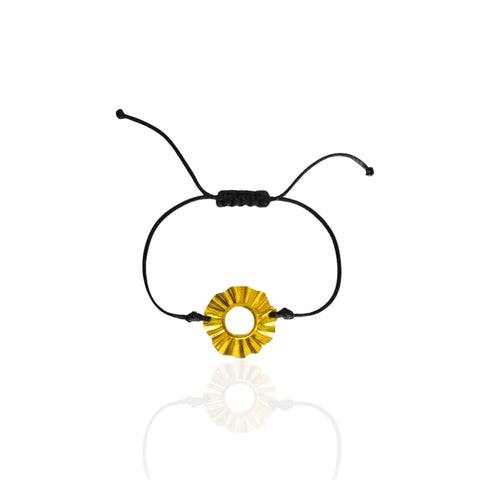 Black cord bracelet with a gold circular charm on a white background. Sun Lucky charm forever 