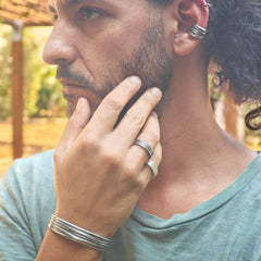 Man wearing rings, braceelt and ear  cuff, unisex rocker style jewelry for both men and women by Athenart . Original jewelry Wholesale available 