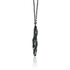 Athenais Drapé Pendant in oxidized 925 silver showing dark valleys and highlighted folds, product photo on white background