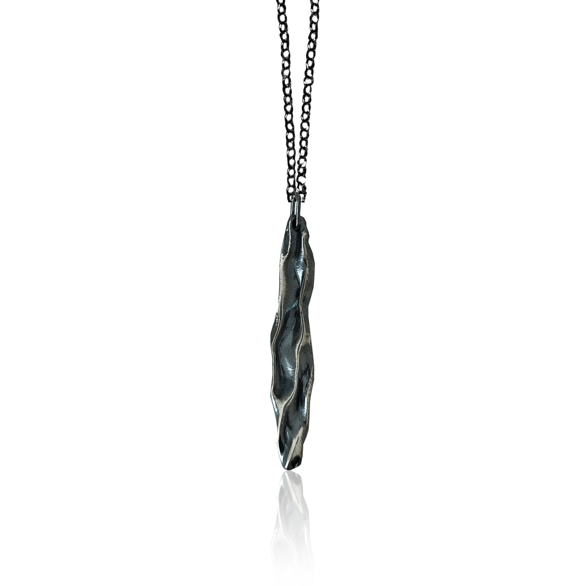 Athenais Drapé Pendant in oxidized 925 silver showing dark valleys and highlighted folds, product photo on white background