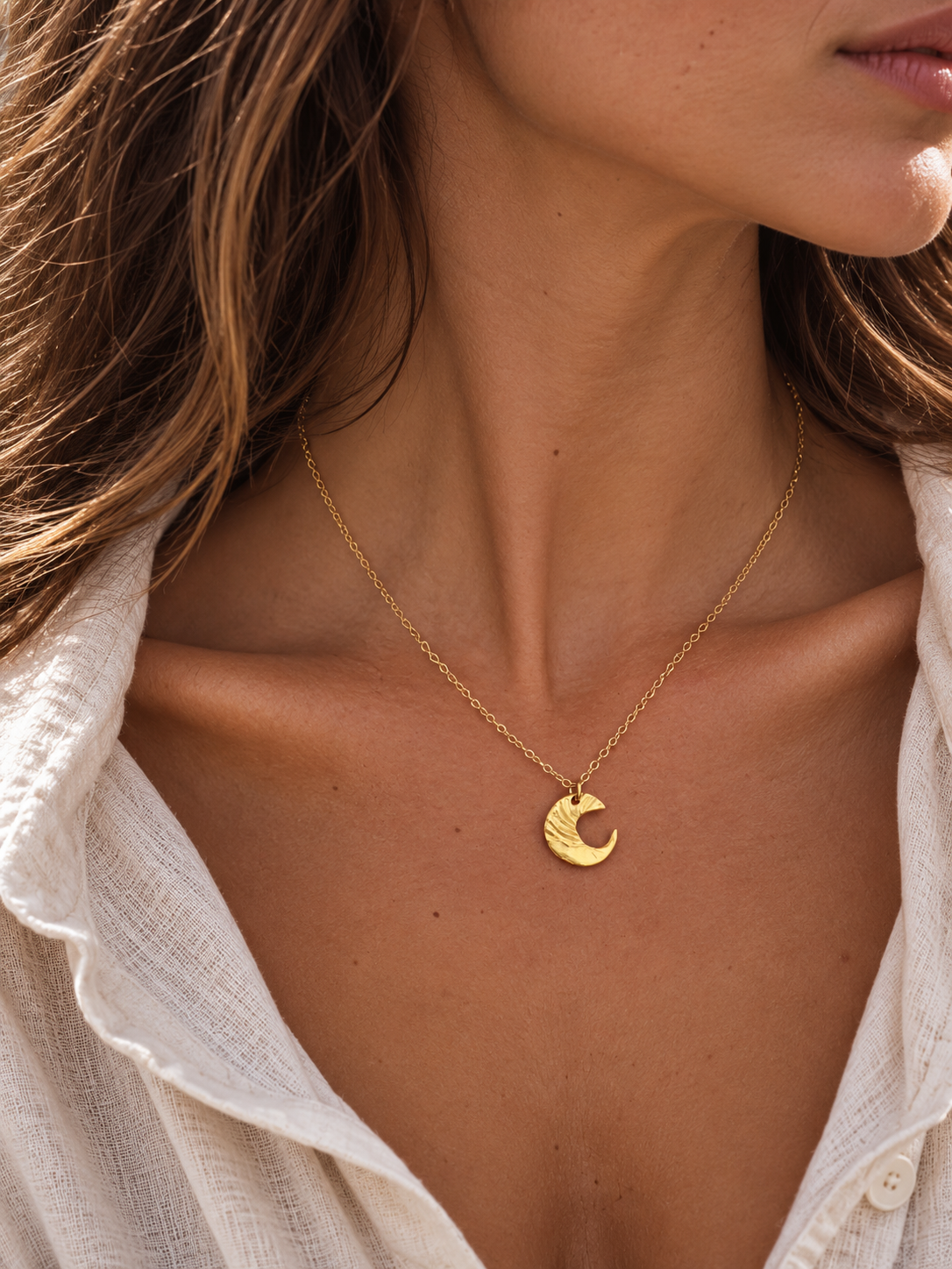 Two-tone Moon Whisper crescent moon necklace worn with a gold-plated chain