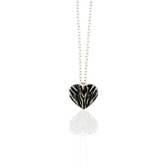 Necklace with a folded  silver heart pendant on a white background