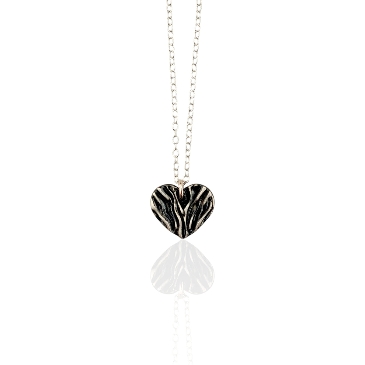Necklace with a folded  silver heart pendant on a white background