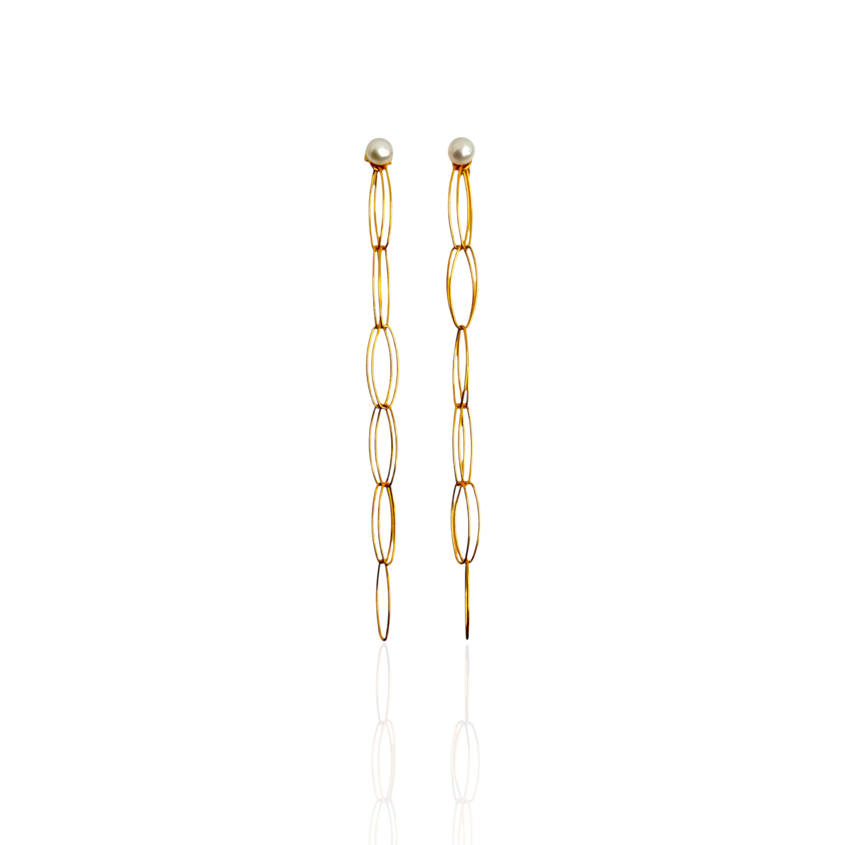 Gold chain earrings with pearl-like ends on a white background
