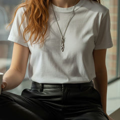 Athenais Drapé Pendant in silver on medium-length chain, lifestyle portrait indoors with natural light