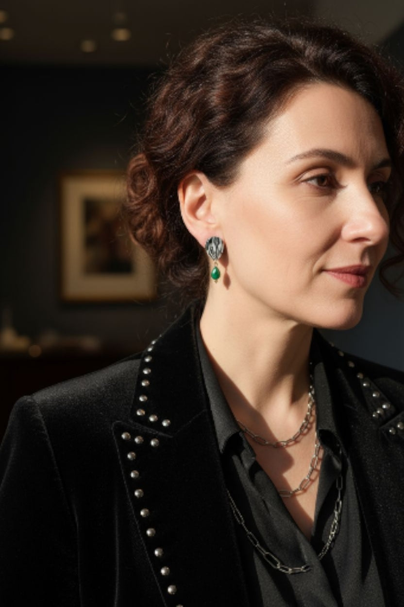 Woman wearing Peplos green onyx earrings, dark textured teardrop with green drop