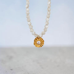 Handmade sun charm necklace with pearl and seashell beads