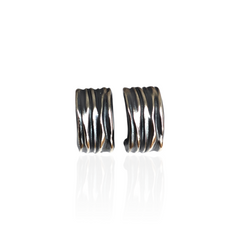 Pair of silver hoop earrings on a white background