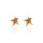 Pair of gold star-shaped earrings on a white background