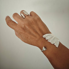 Peplos Aura Cuff Bracelet worn on hand with matching Peplos ring in silver