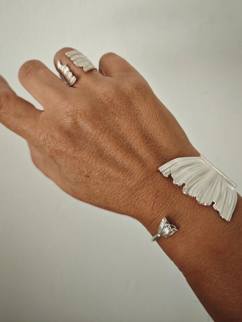 Peplos Aura Cuff Bracelet worn on hand with matching Peplos ring in silver