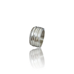 Silver ring with embedded stones on a white background