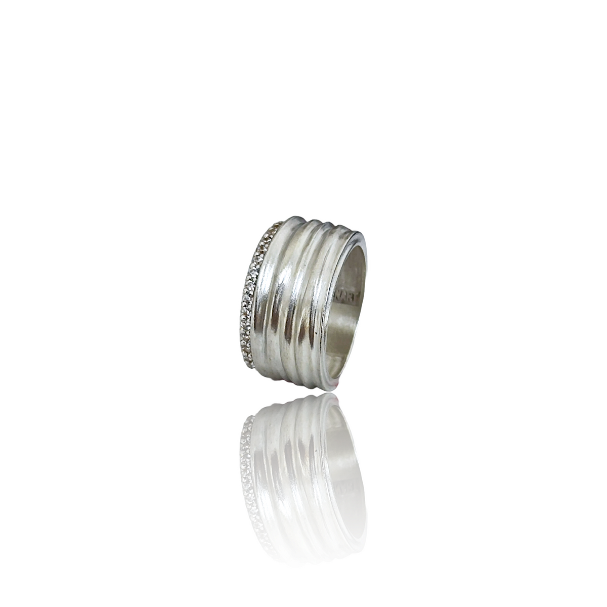 Silver ring with embedded stones on a white background