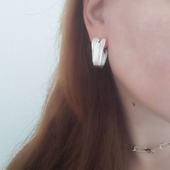 Side view of model with Swan Hoops – folds inspired by Greek drapery.