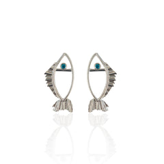 Pair of silver fish-shaped earrings with blue gemstones on a white background