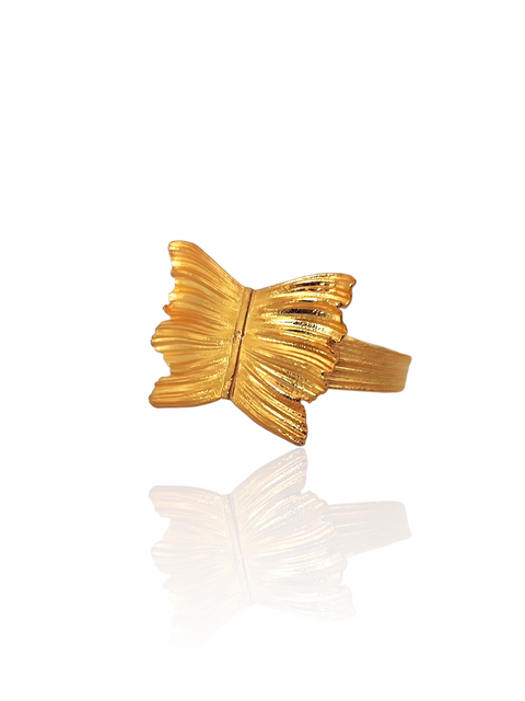Gold butterfly-shaped ring on a white background