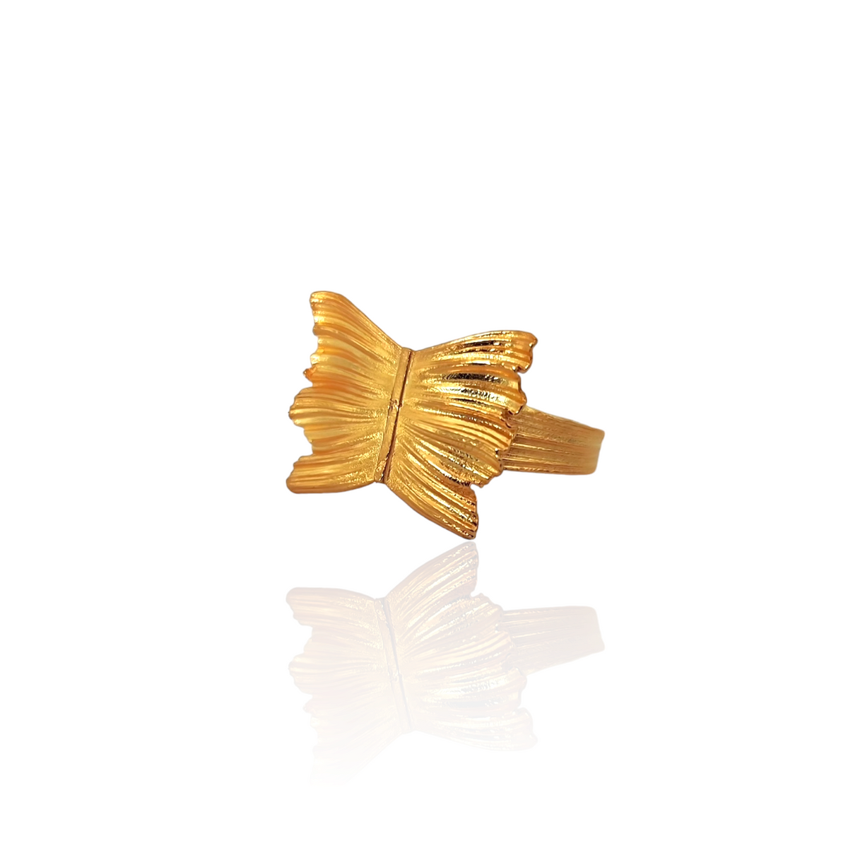 Gold butterfly-shaped ring on a white background