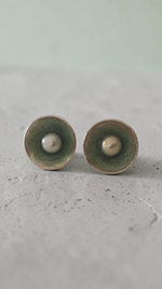 Editorial close-up of a model wearing handmade Nerida pearl stud earrings by Athenart Jewelry