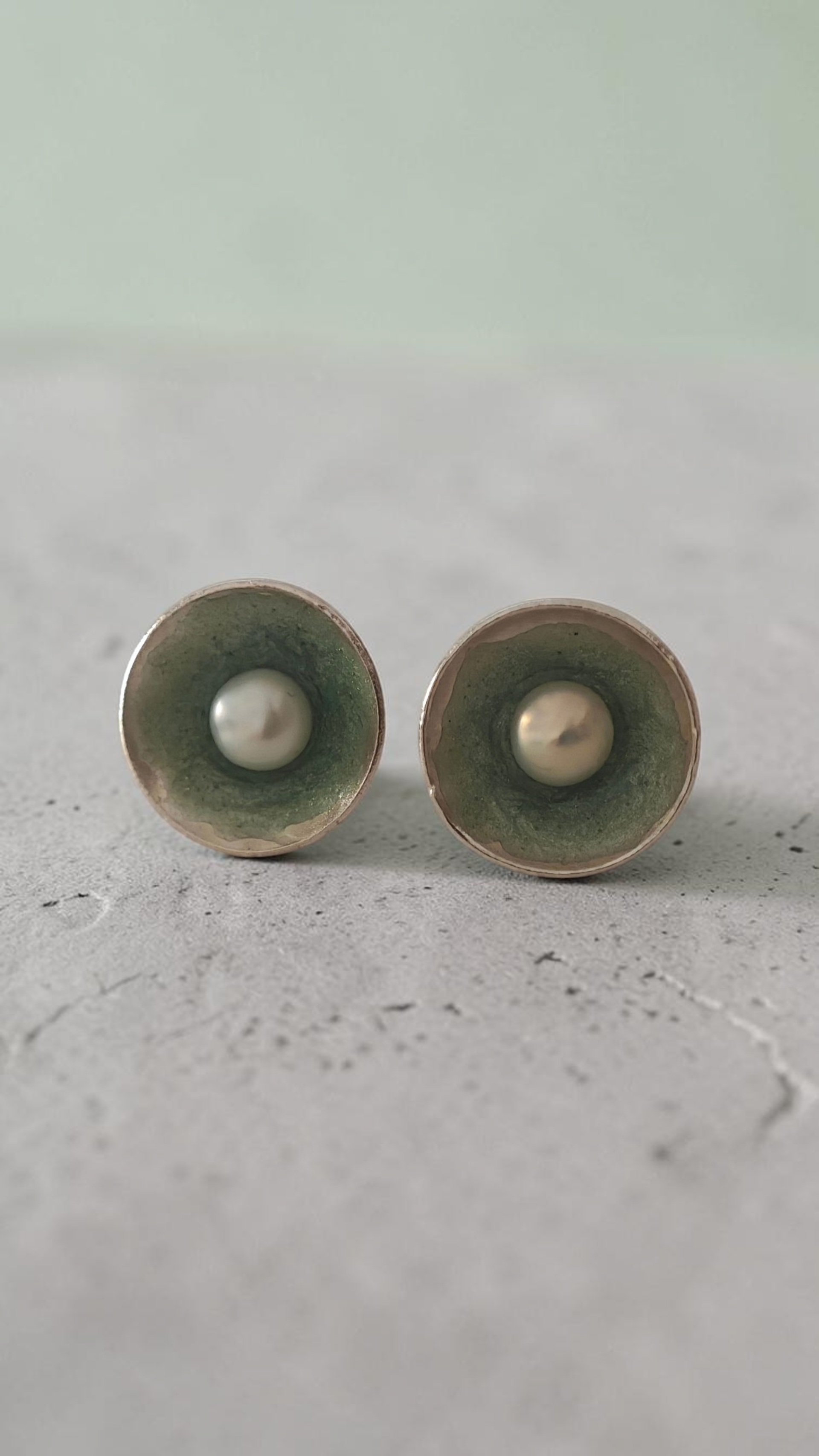 Editorial close-up of a model wearing handmade Nerida pearl stud earrings by Athenart Jewelry