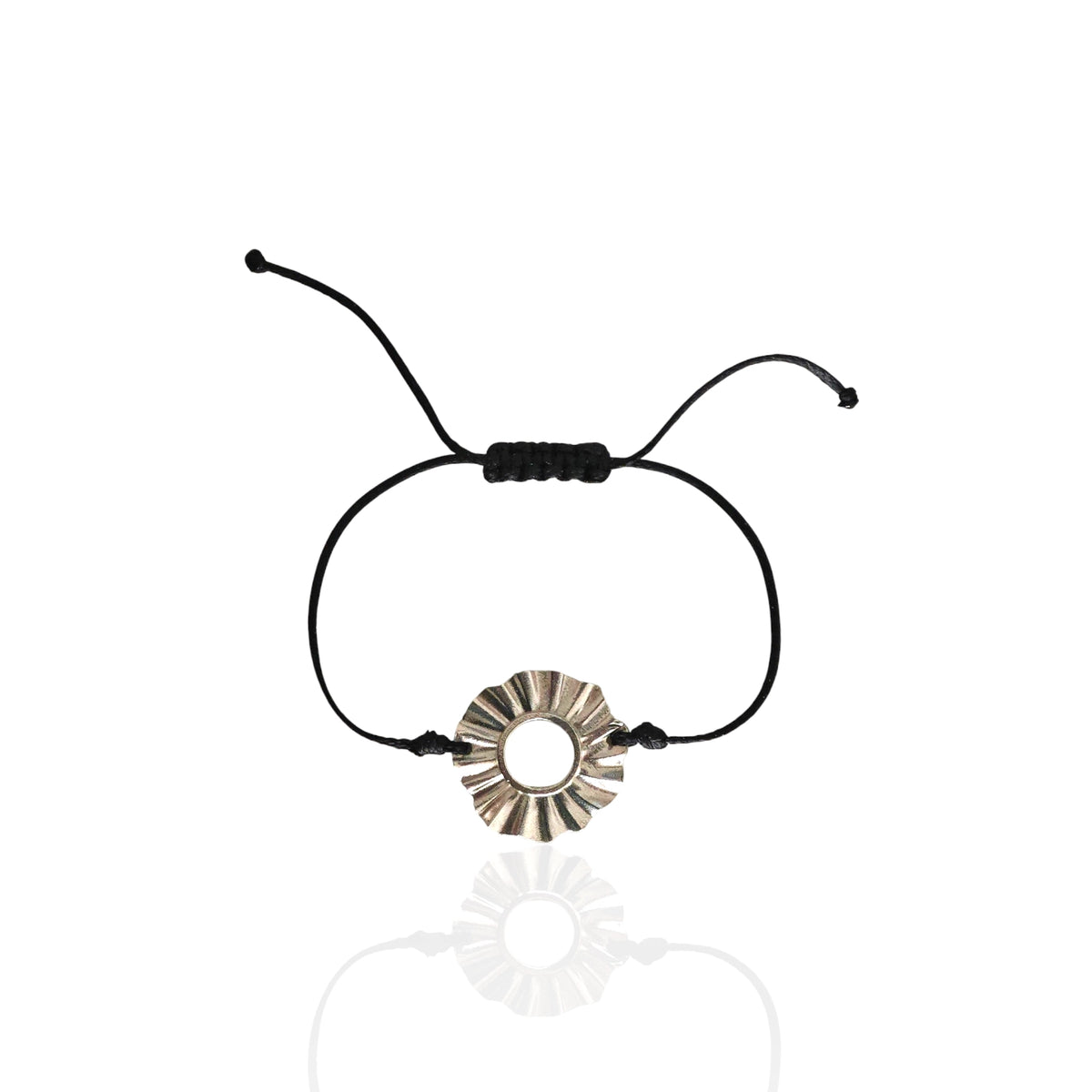 Black cord bracelet with a silver circular charm on a white background