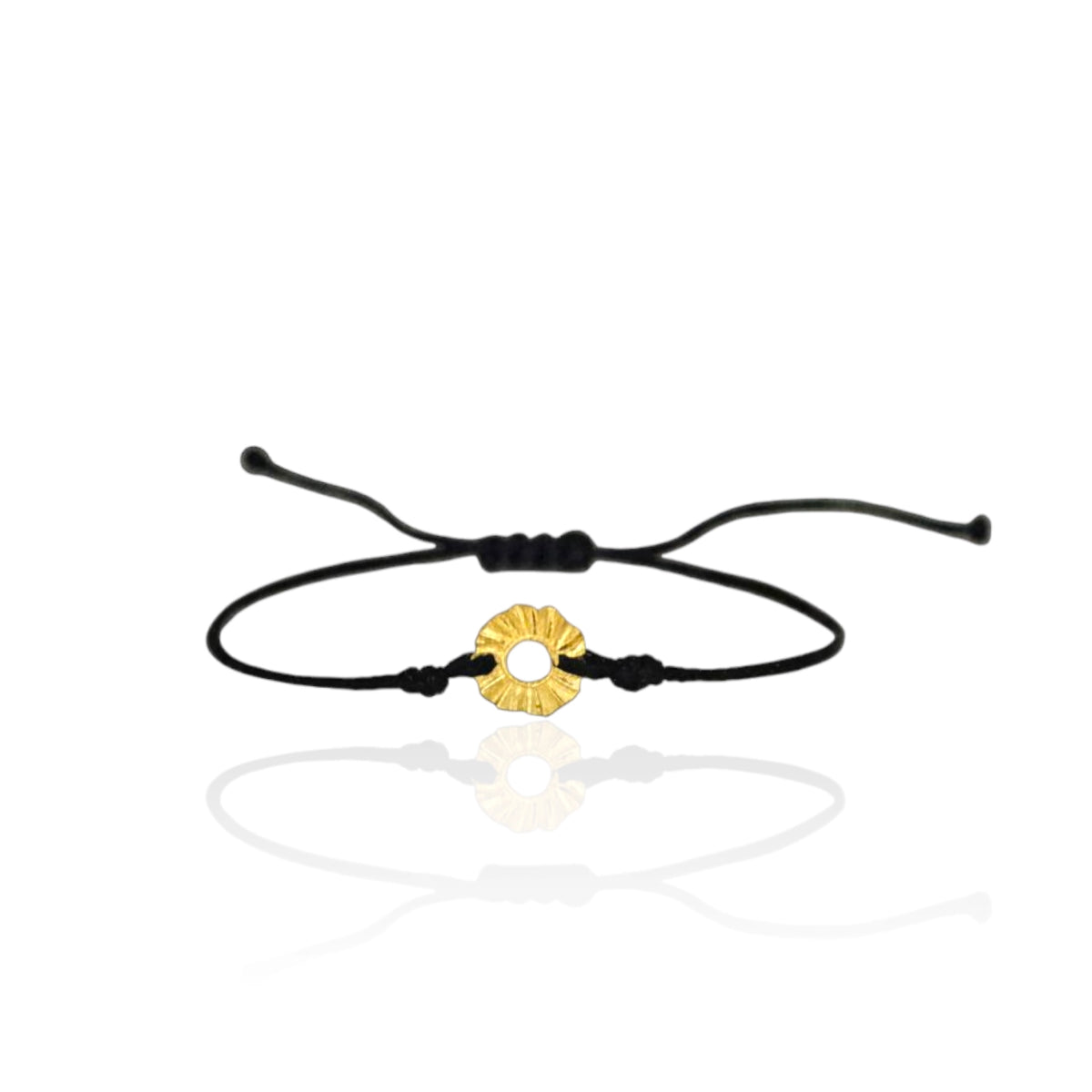 Black cord bracelet with a gold circular charm on a white background