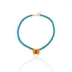 Turquoise beaded necklace with a gold clasp on a white background