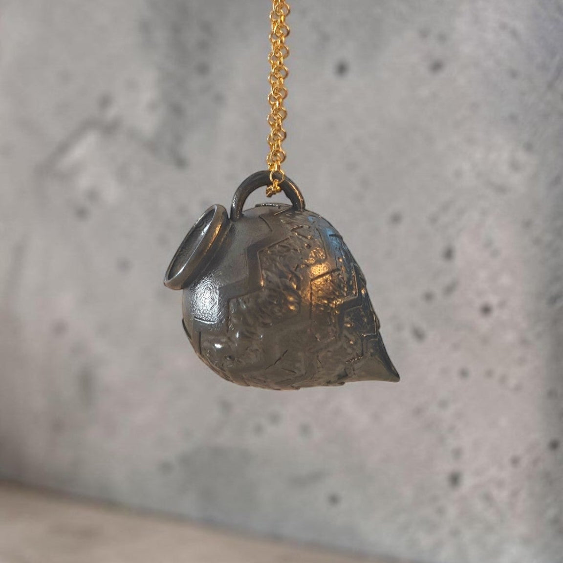 Sculptural oxidized silver Amphora pendant suspended from a gold-plated chain