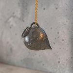 Sculptural oxidized silver Amphora pendant suspended from a gold-plated chain
