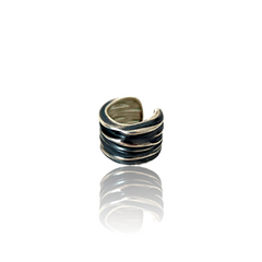 Silver and black striped ring on a white background