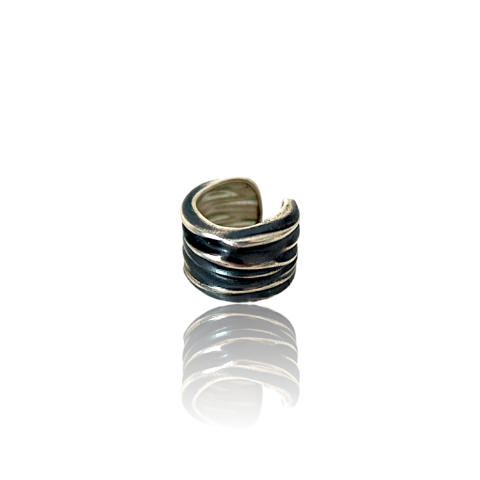 Silver and black striped ring on a white background