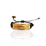Peplos drapé bar cord bracelet in gold plated finish on white background