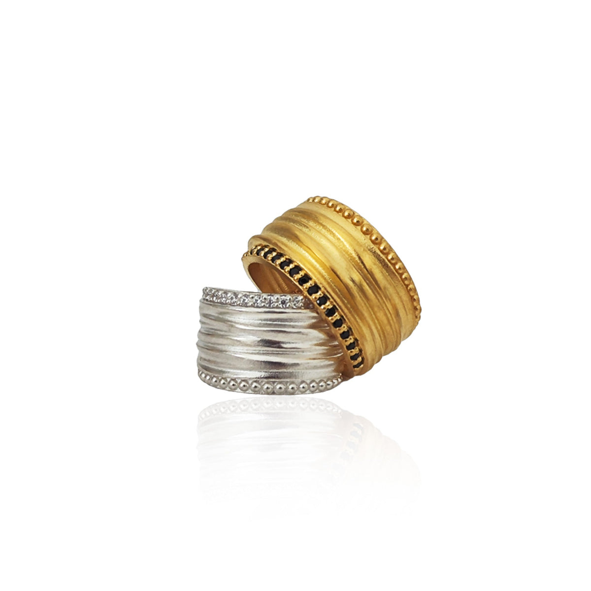 Two rings, one gold and one silver, on a white background