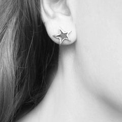 Star stud earrings handmade in silver – worn on ear