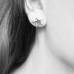 Star stud earrings handmade in silver – worn on ear