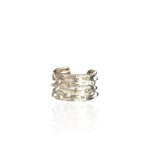 Silver non pierced earrings with textured design on a white background