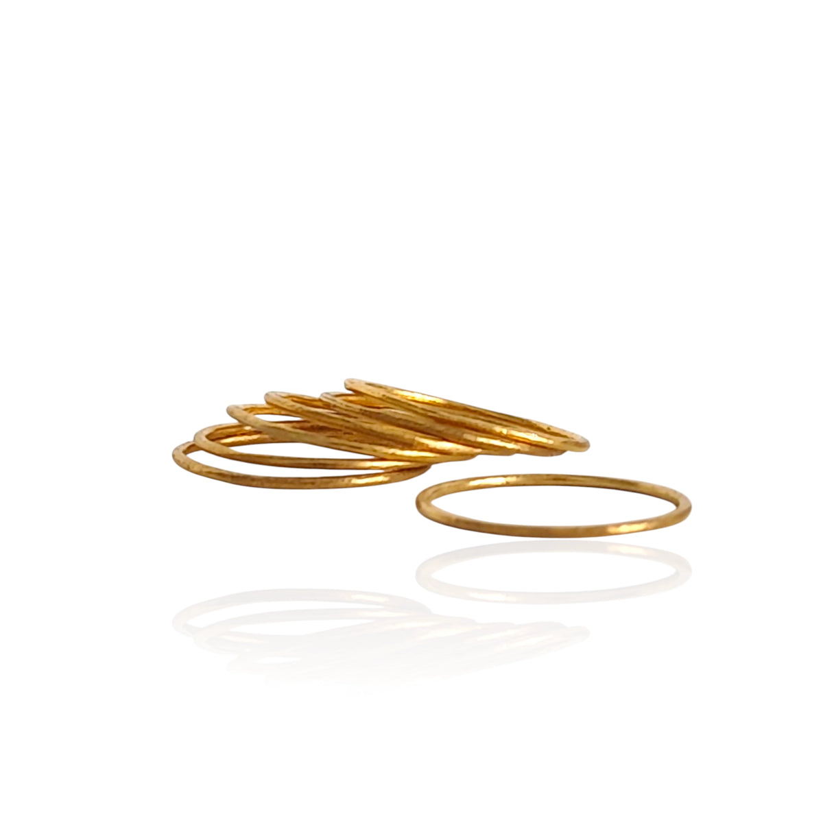 Gold bangles on a white background