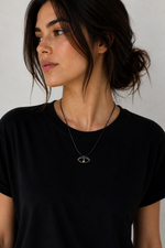 Minimal eye talisman necklace in oxidized silver finish on black cord by Athenart