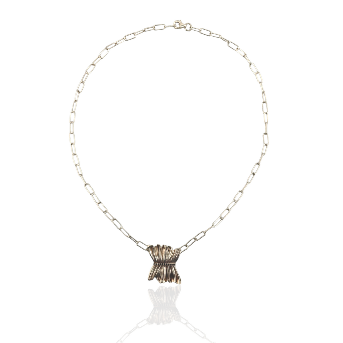 Necklace with a textured pendant on a white background